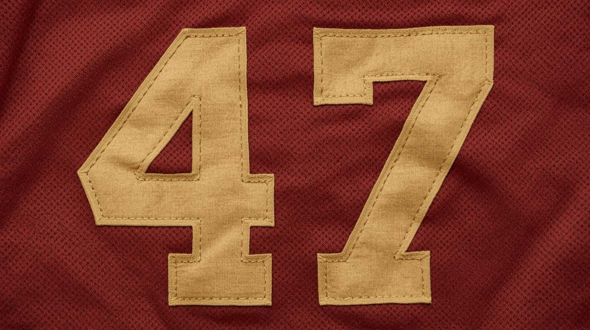 Image of a red with white sewn on numeral football Jersey number 47
