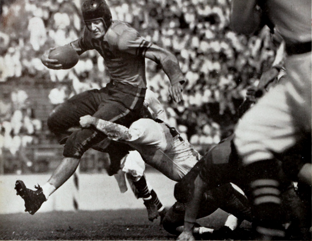 black and white game action image of number 66 Banks McFadden carries the ball for Clemson in a 1939 game against Tulane.