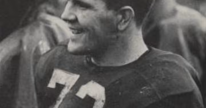 black and white Yearbook photo of Alabama number 73 Billy Neighbors on sideline during NC State game