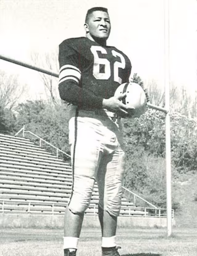 black and white photo shoot image of number 62 Iowa player Cal Jones 1956