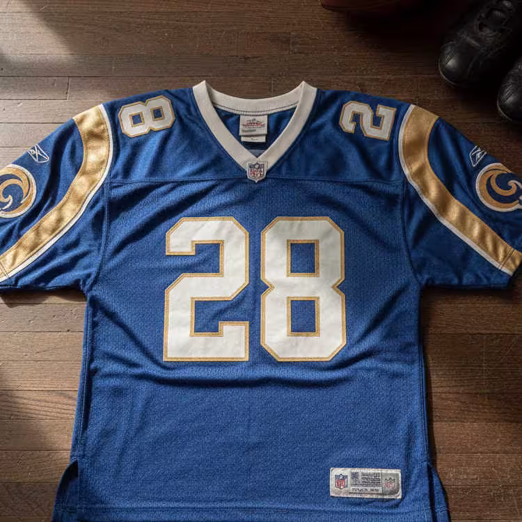 Image of a blue Rams NFL football Jersey number 28