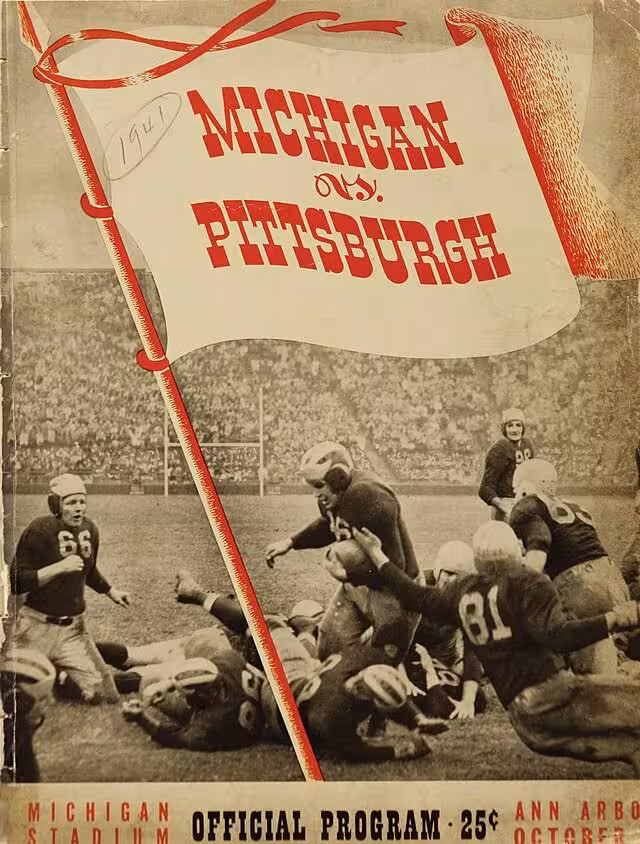 Action phot of Michigan Wolverines players running the ball with a full stadium crowd int he back ground, with a drawn pennant promoting the Michigan vs Pittsburgh game at Michigan stadium, ..Program cover