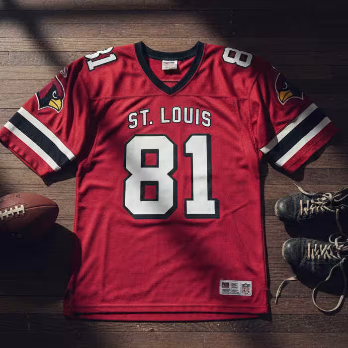 Image of a red St Louis Cardinal football Jersey number 81 with a football and old cleats.