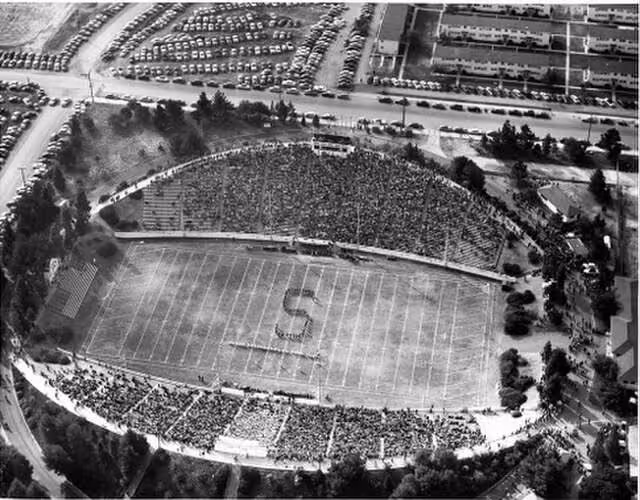 black and white newspaper image of Spartan Stadium in an aeriel views of the band forming an "S" midfield.