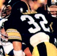A close-up action shot of Pittsburgh Steelers fullback Franco Harris (32) rushing with the football during Super Bowl XIV against the Los Angeles Rams. This image is a crop from a 1986 Jeno's Pizza NFL football card sticker.