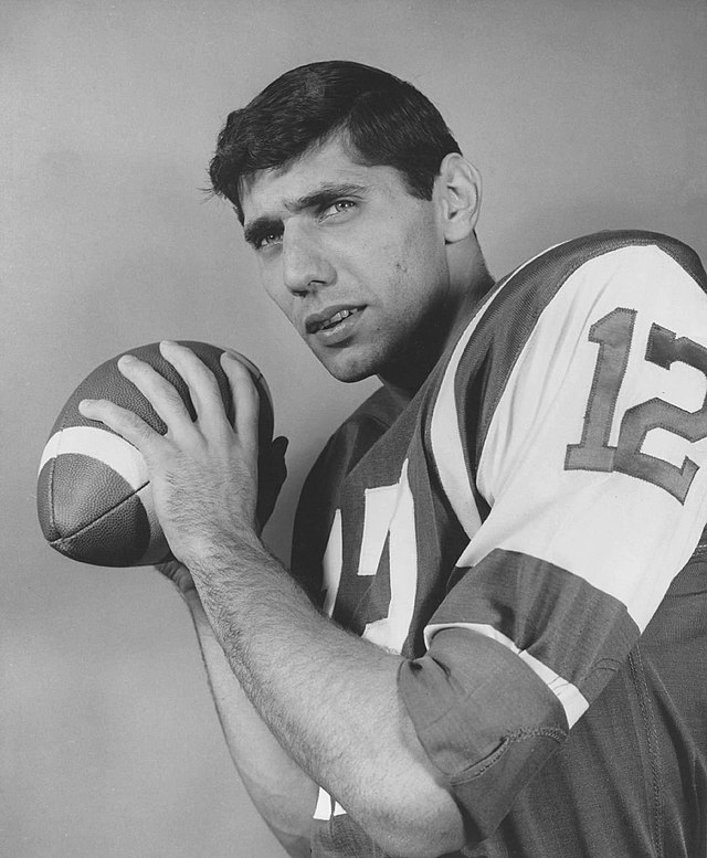 Vintage 1965 promotional photograph of New York Jets quarterback Joe Namath. Black and white archival image showing Namath (#12) in a passing pose, capturing his rookie year after leaving Alabama for the AFL. A primary source for historical NFL merger and Western Pennsylvania sports research for Pigskin Dispatch archives.