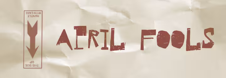 off white background that appears as crinkled paper with a reddish writing of "April Fools Day" and an upside down "This Side Up" logo.
