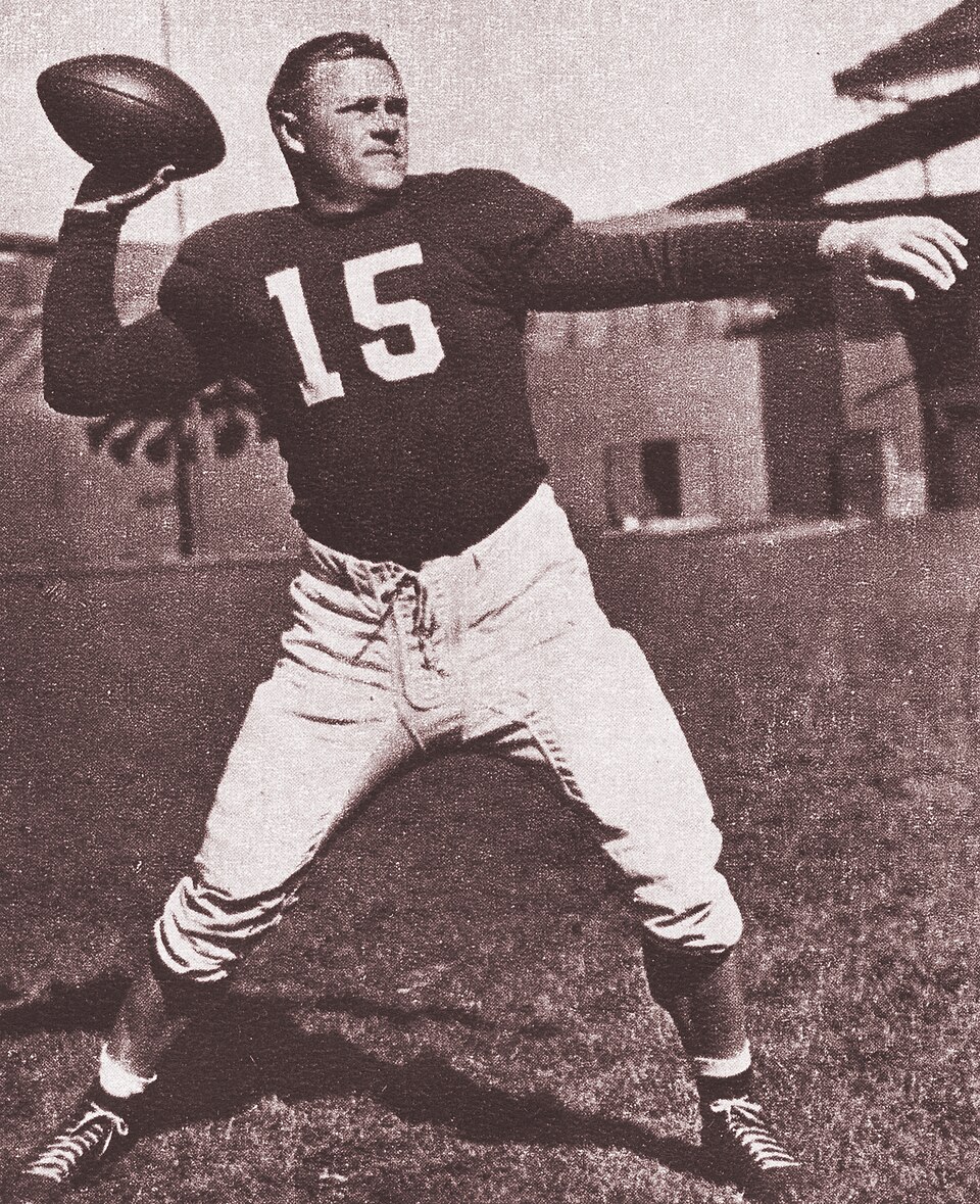image of Paul Christman wearing a number 15 jersey posing throwing a pass