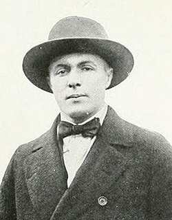 A black-and-white studio portrait of Herbert Young from the College of William & Mary. He is wearing a dark, heavy-knit vintage football sweater with a high ribbed collar and a light-colored 'W' patch sewn onto the chest. He is looking slightly off-camera with a serious expression.