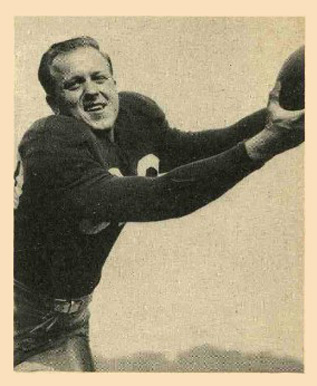 A black-and-white action photograph featured on a 1948 Bowman football card. The image shows Malcolm Kutner reaching upward with both hands to secure a football. He is wearing a dark, long-sleeved Chicago Cardinals jersey with his number partially visible on the shoulder. The shot is a classic 'posed action' photo from the mid-century, set against a simple, pale sky background.