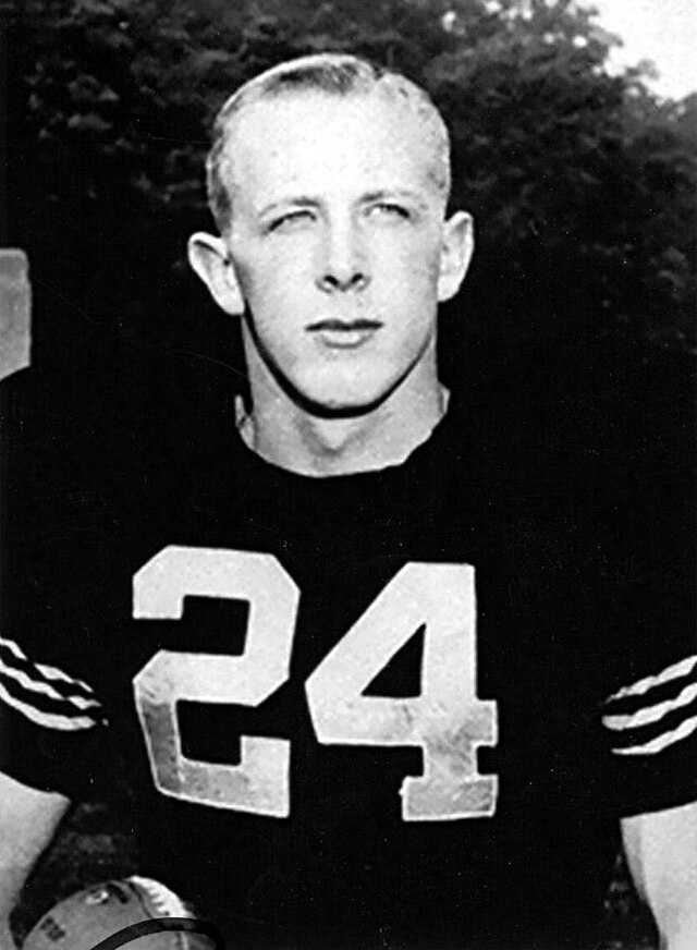 Vintage portrait of Army football legend Pete Dawkins in his #24 jersey holding a football.