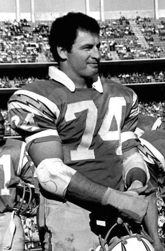 black and white upper torso image of Ron Mix wearing his San Diego Chargers number 74 uniform with his helmet off