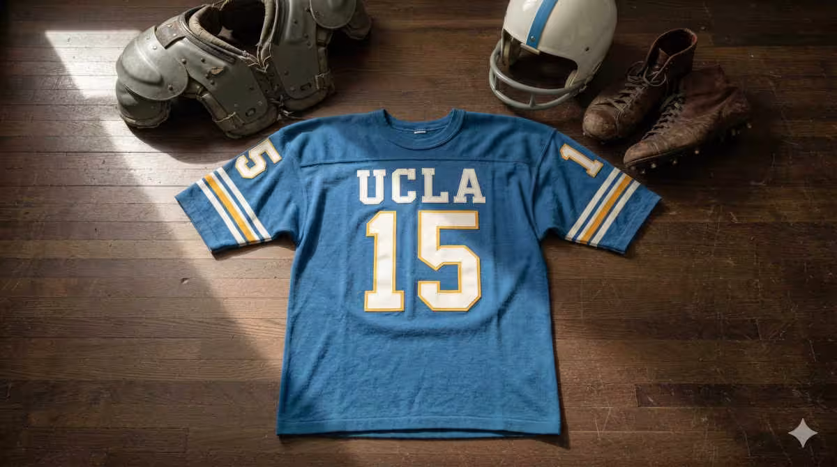 Image of a blue football UCLA Jersey number 15 with a football helmet and old cleats.