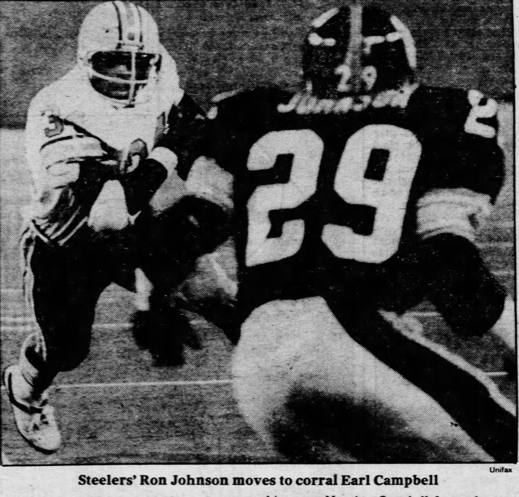 Black and white 1979 NFL action photo of Pittsburgh Steelers cornerback Ron Johnson #29 attempting to tackle Houston Oilers running back Earl Campbell #34. Authentic Unifax news wire image from the AFC Central rivalry at Three Rivers Stadium.