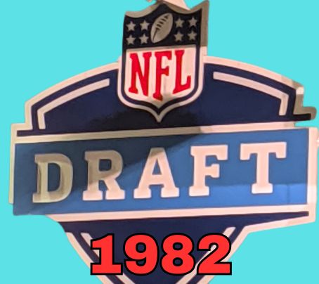 NFL Draft sign in color on a aqua background with the year 1982 text across the bottom in bright red. Original cropped image was taken by Darin Hayes at AT&T Stadium in 2022.