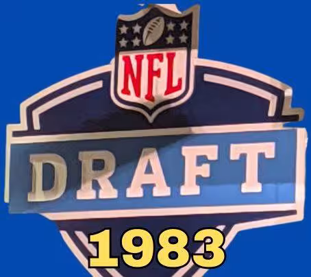 NFL Draft sign in color on a blue background with the year 1983 text across the bottom in yellow. The original cropped image was taken by Darin Hayes at AT&T Stadium in 2022.