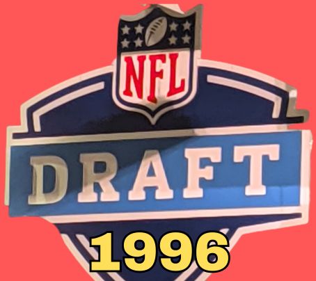NFL Draft sign in color on a reddish background with the year 2002 text across the bottom in bright yellow. Original cropped image was taken by Darin Hayes at AT&T Stadium in 2022.