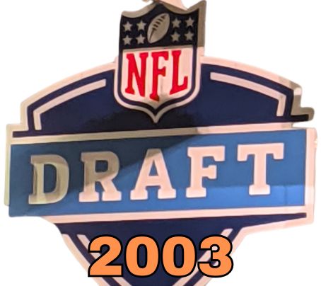 NFL Draft sign in color on a white background with the year 2003 text across the bottom in bright orange. The original cropped image was taken by Darin Hayes at AT&T Stadium in 2022.