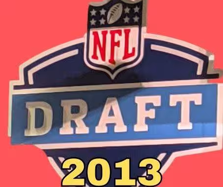 NFL Draft sign in color on a reddish background with the year 2013 text across the bottom in bright yellow. The original cropped image was taken by Darin Hayes at AT&T Stadium in 2022.