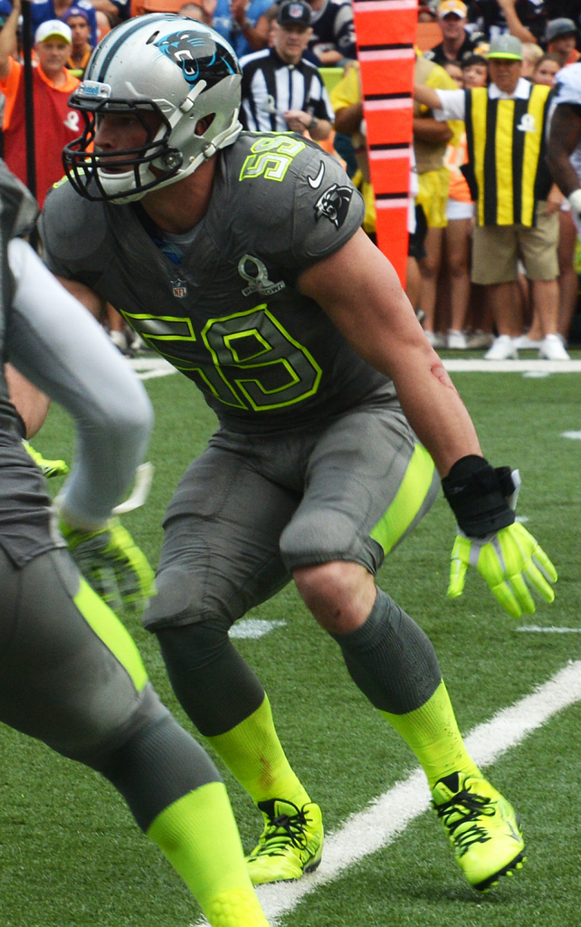 Color Action photo of Luke Kuechly in 2014 Pro Bowl wearing an all gray uniform number 59 with bright yellow stripes and his Carolina Panther helmet.