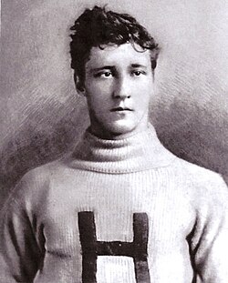 A black-and-white archival portrait of Harvard football player Marshall Newell from the early 1890s. The image shows a young man with wavy hair wearing a high-collared, ribbed wool sweater featuring a large, dark block letter 'H' on the chest. He has a stoic, direct expression. The photograph has the soft focus and textured background characteristic of late-Victorian era athletic studio portraits.
