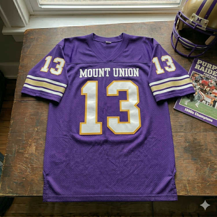 Vintage Mount Union Purple Raiders #13 football jersey. Purple mesh with white and gold block numbers, 1990s National Champions program, and gold helmet with 'M' logo for historical Division III sports research and Pigskin Dispatch archives.