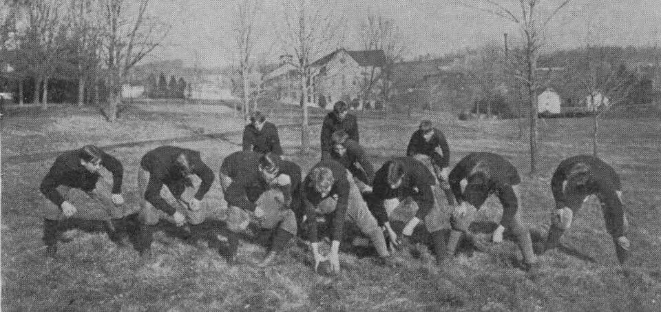 vintage black and white image of the Virginia PI football team in an offensive formation.