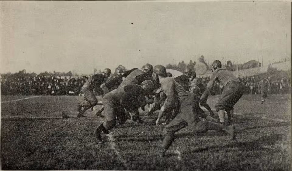 black and white vintage game action photo of A scene from an unknown football game featuring the 1912 Georgia Tech Yellow Jackets. The caption reads, "An exciting moment in one of the most important foot ball games".