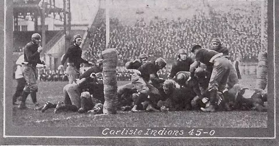 Vintage black and white photo of 1915 Pitt versus Carlisle football game action