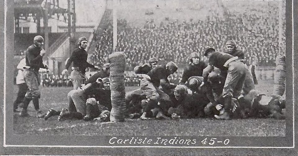 Vintage black and white photo of 1915 Pitt versus Carlisle football game action