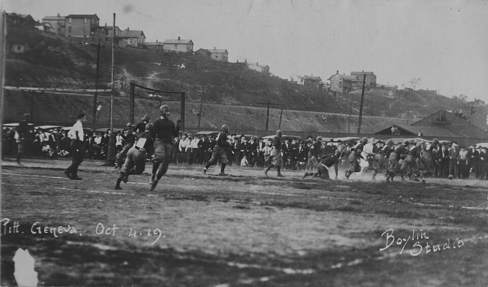 Vintage black and white game action photo of 1919 football game action between Pitt and Geneva