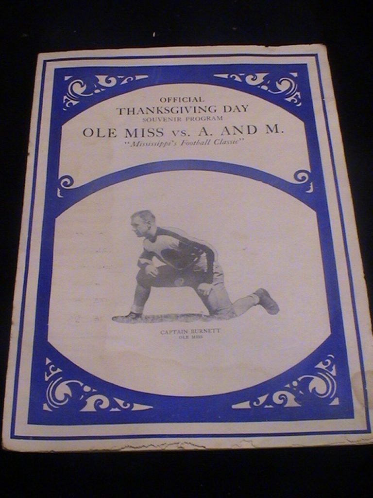 Vintage off white game program cover with blue border and an image of a player kneeling, Photo of my 1929 Ole Miss vs. Mississippi A&M football program University of Mississippi