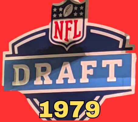 NFL Draft sign in color on a reddish background with the year 1979 text across the bottom in yellow. The original cropped image was taken by Darin Hayes at AT&T Stadium in 2022.