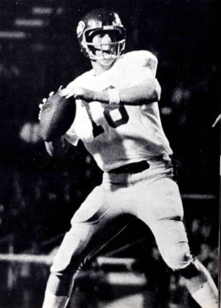Vintage black and white game action photo of Archie Manning in 1969 at Ole Miss throwing a pass.