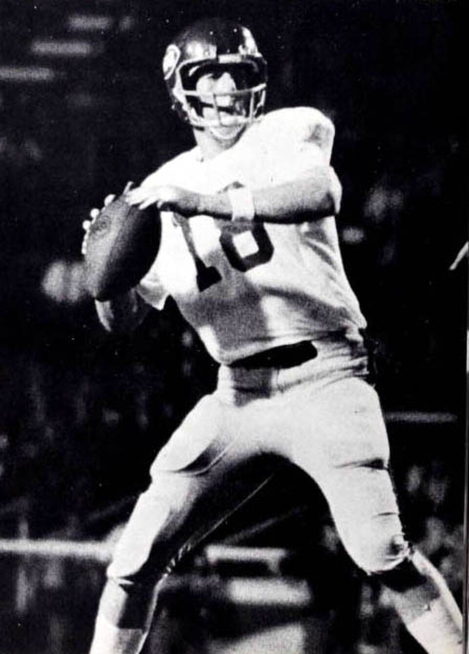 Vintage black and white game action photo of Archie Manning in 1969 at Ole Miss throwing a pass.