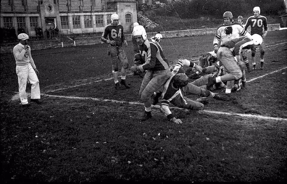 vintage black and white game action photo of Football game between the Montreal Indians and the Toronto Argonauts at McGill University's Molson Stadium in Montreal, Canada.