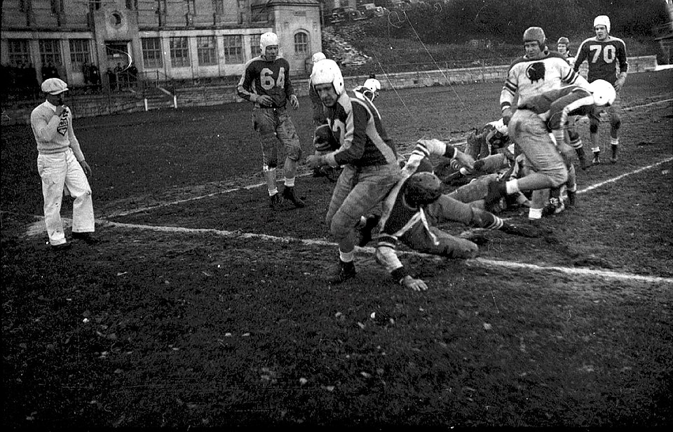 vintage black and white game action photo of Football game between the Montreal Indians and the Toronto Argonauts at McGill University's Molson Stadium in Montreal, Canada.