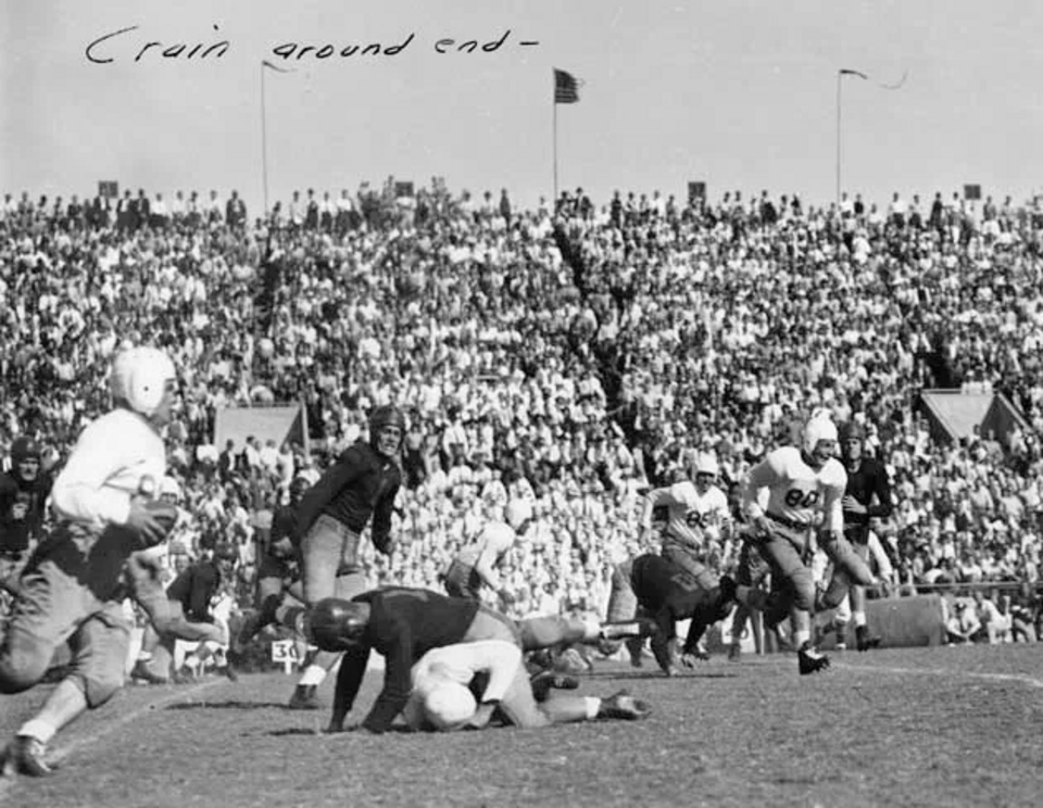 Vintage black and white game action photo of Texas' Jack Crain scored a last second 67 yard touchdown to give texas a narrow 14-13 victory over conference rival Arkansas on October 21, 1939.