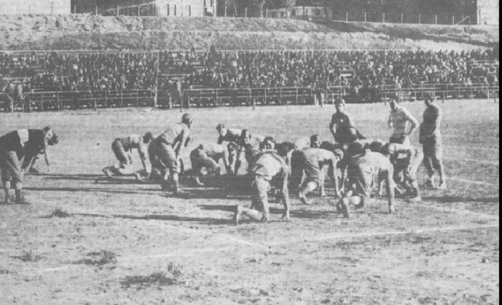 A black and white vintage photo of Creighton football game action 1910