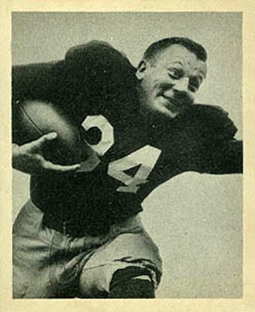 Vintage black and white publicty phot of Pat Harder in a dark uniform jersey 34 carrying a football