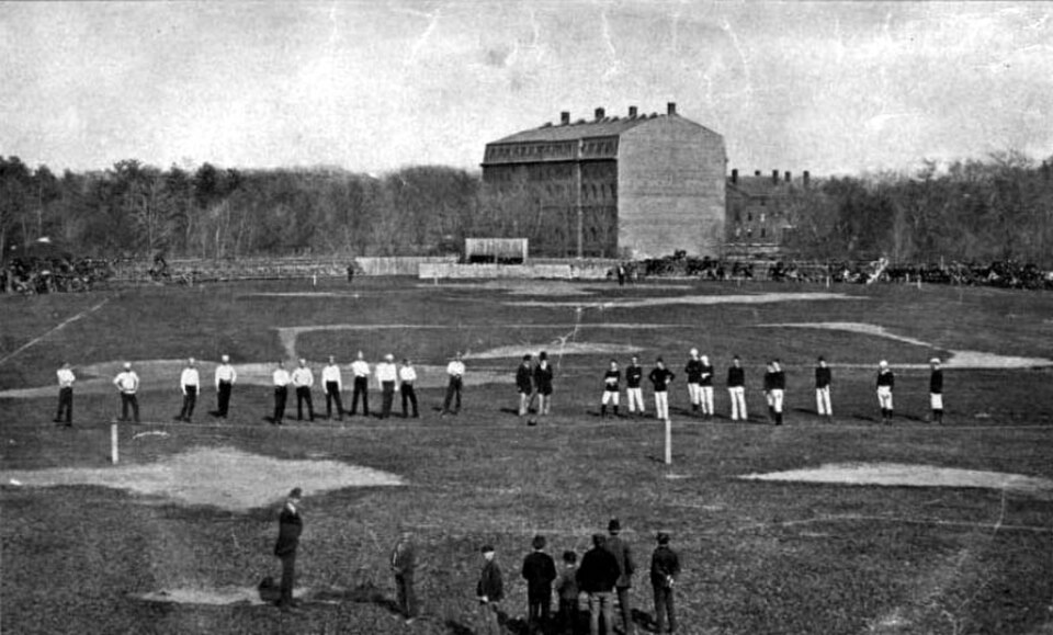 Vintage black and white image of May 15, 1874 The second Harvard-McGill football game, played under the rugby rules. The Harvard players are on the left (in white), and the McGill players on the right. They flank the game officials.