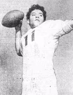 Vintage black and white newspaper publicity photo of American football player Herman Wedemeyer, in his all white St. Mary's Gaels football uniform jersey 11, posing to throw a pass without a helmet on.