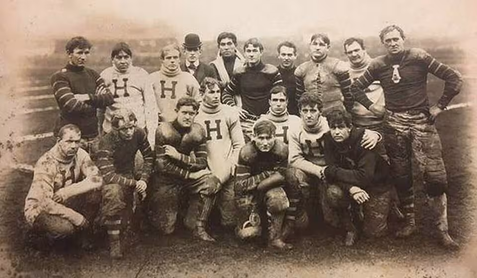 black and white team photo foHomestead Library Athletic Club football team, 1900. Standing, left to right: Pete Overfield, Artie Miller, Charles Farr, Bill Church, Bemus Pierce, Merrill Hibbard, George Brooke, M. P. McNulty, John Winstein, P. J. Lawler. Sitting/kneeling: John Hall, Art Poe, J. A. Gammons, Grenville Lewis, Willis Richardson, George Young, Otto Wagenhorst, Dave Fultz.