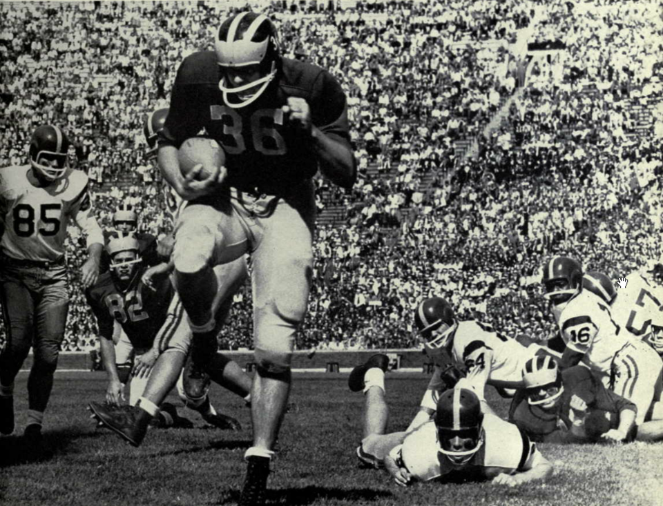 Vintage black and white game action photo of Photograph of John Herrnstein scoring a touchdown in a football game against the USC Trojans on September 27, 1958.
