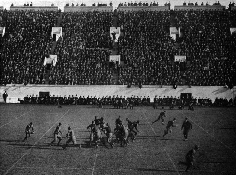 Vintage black and white game action photo of Penn vs Harvard 1904