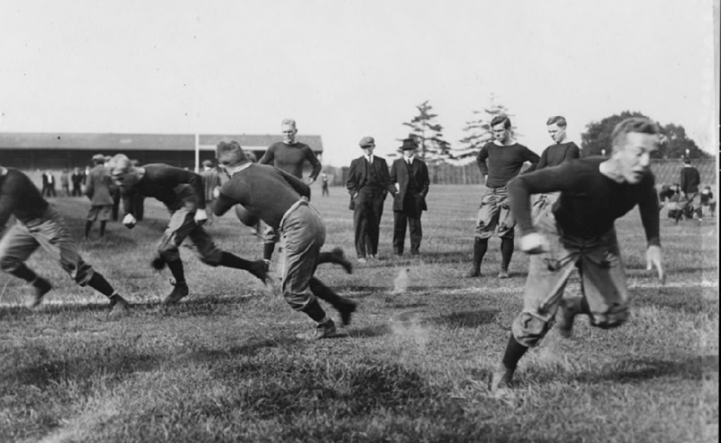 Black and white vintage photo of Yale football game action against Harvard 1910