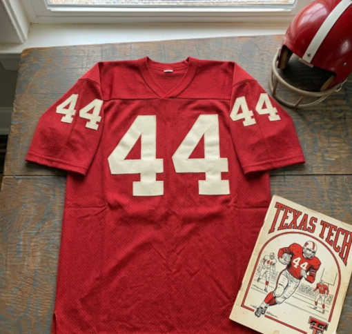 Vintage Texas tech #44 football jersey . Red mesh with white blue d block numbers. Includes a crimson helmet and a vintage Texas Tech football program .