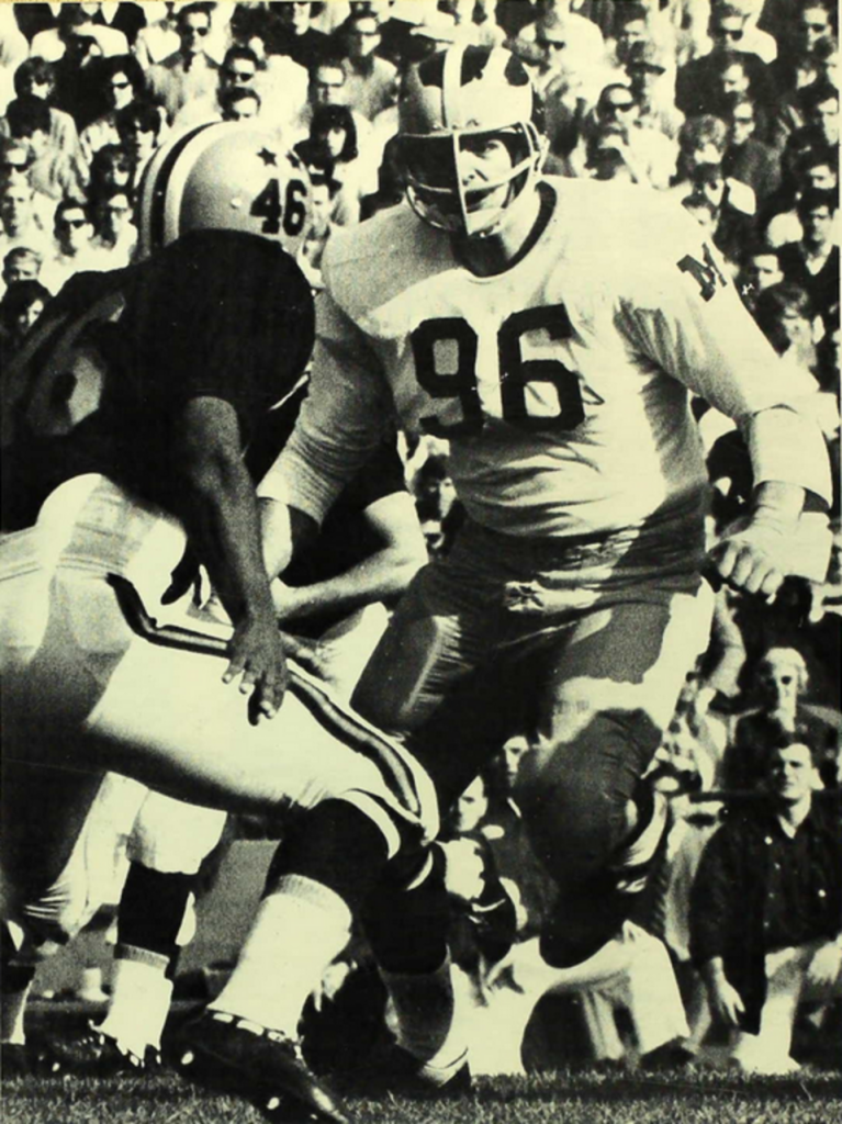 black and white game action Photograph of Michigan's Tom Mack in 1965.