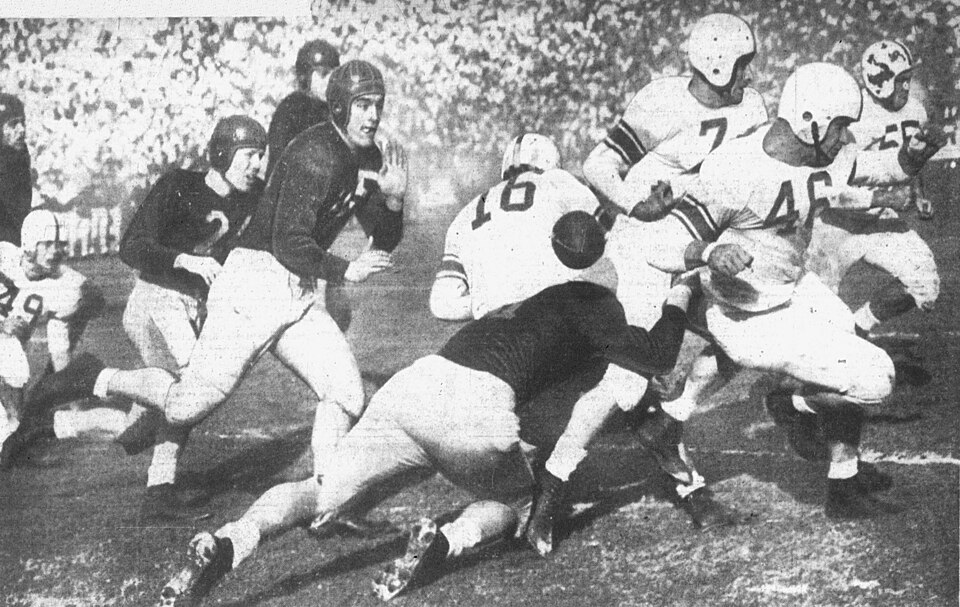 Vintage black and white game action photo of the 1947 USC vs UCLA football game
