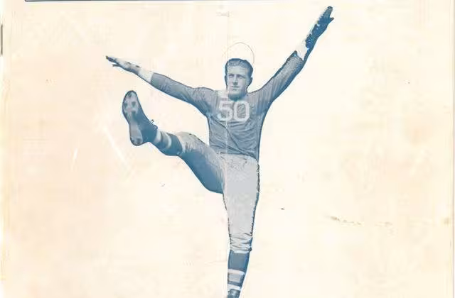 Plain manilla colored program cover with blue and gray writing an an image of Giants player number 50 in a football pose.